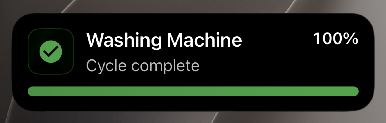 Washing Machine Live Activity showing "Cycle complete" with a full green progress bar